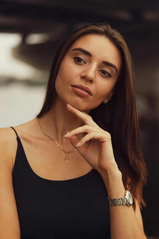 woman sitting looking down wearing a wrist watch