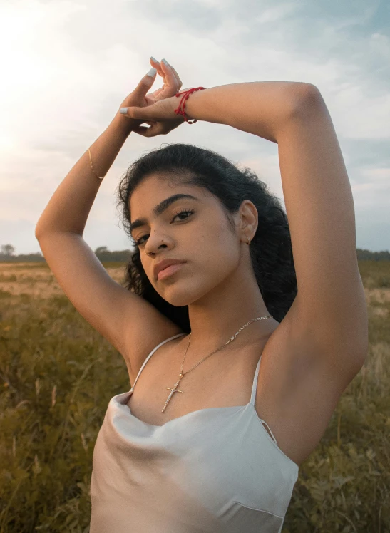 a woman in white shirt holding up her arm