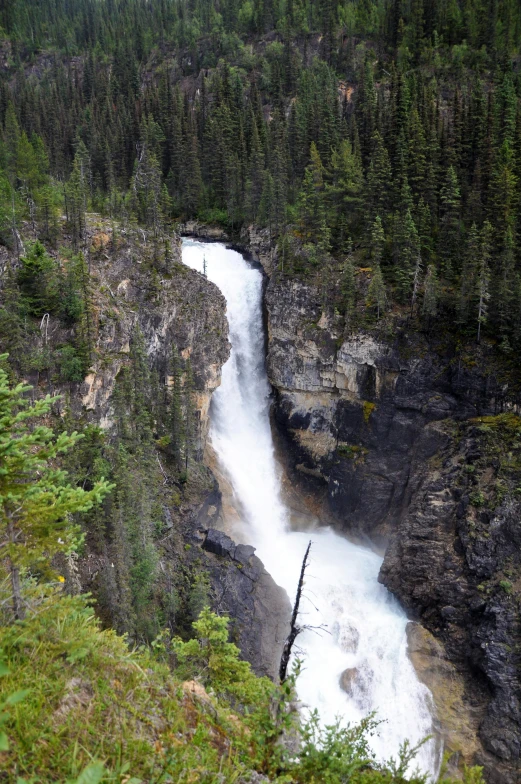 water cascading down a narrow river between two mountains