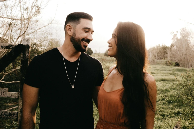 a young man and woman are smiling together