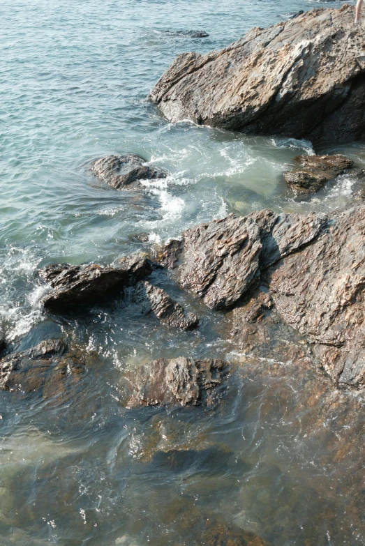 a view of the water with rocks at the shoreline