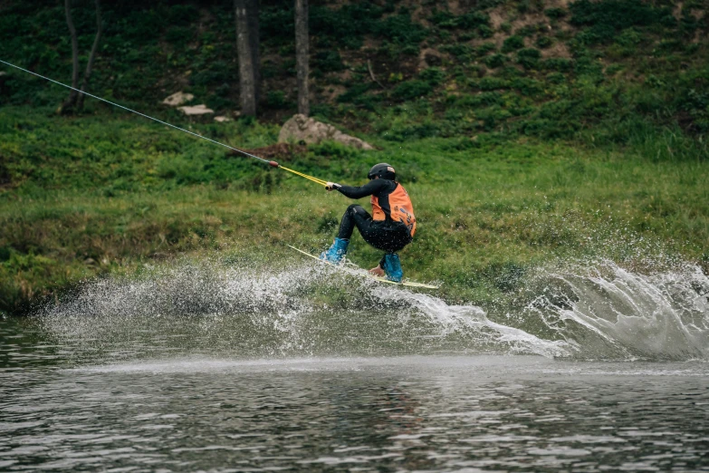 a man riding a wake board on top of water