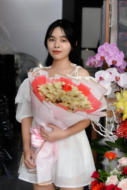 a woman holding up a bouquet of flowers