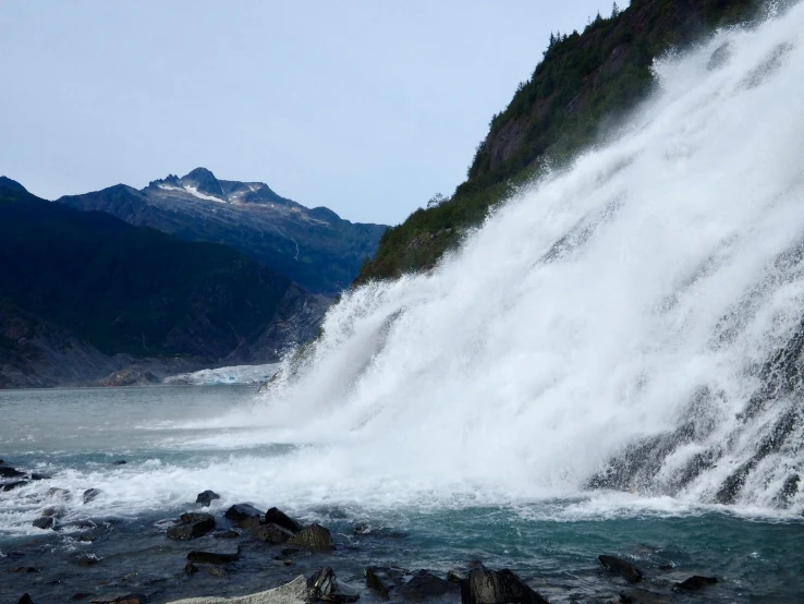 waterfall falling in to the ocean with white water