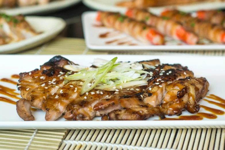 pork chops and noodles are on a white plate