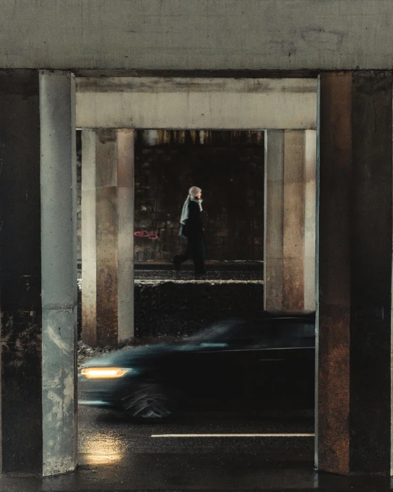 people walking down an indoor passage in an empty building