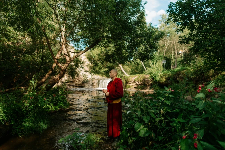 a person in red is looking at the water