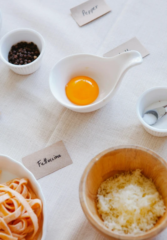 three bowls with different foods, one has eggs and the other has noodles