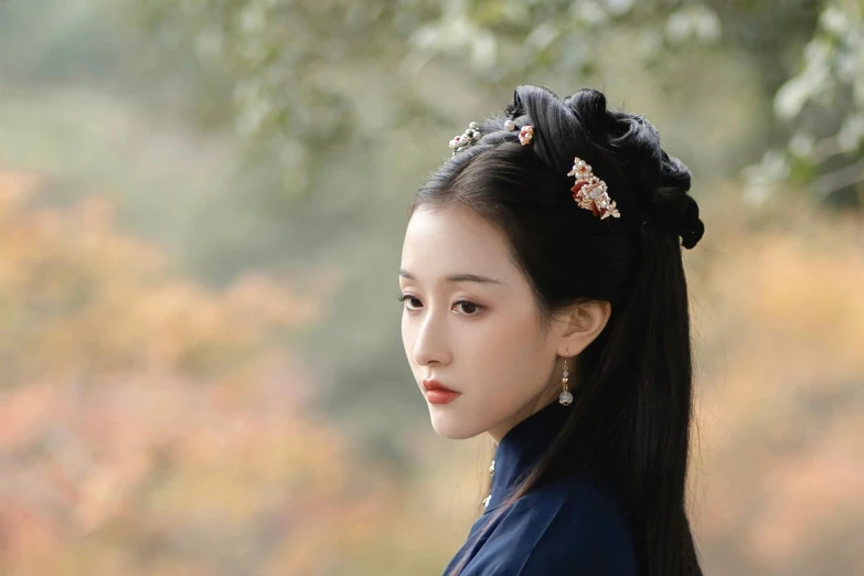 an oriental woman wearing a blue shirt and flower in her hair