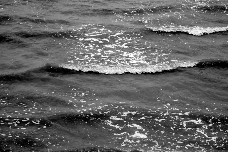 an aerial view of the ocean with waves