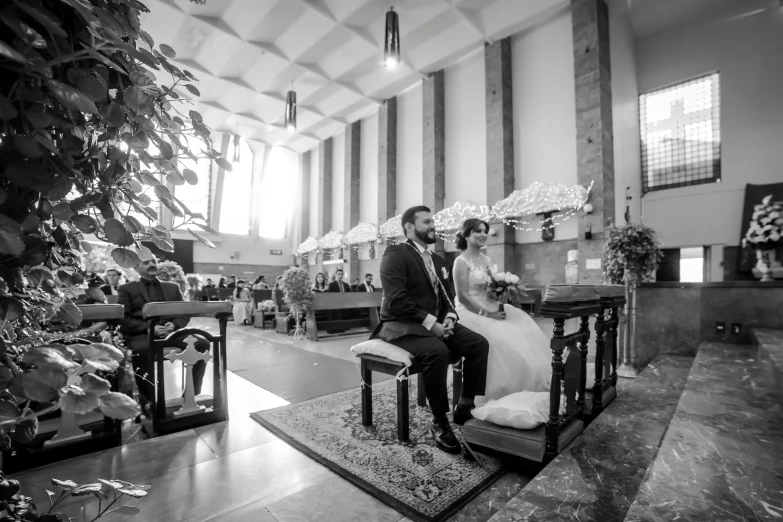 a couple is sitting together at the alter