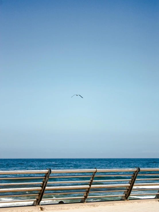 a wooden bench sitting next to the ocean