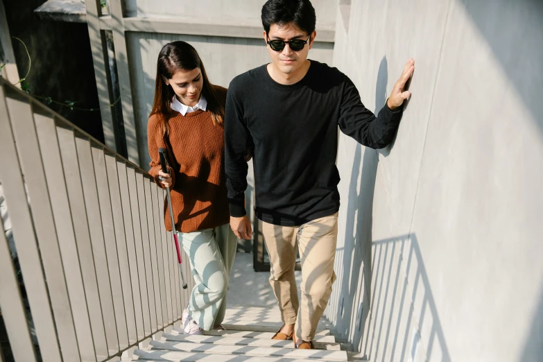 a man and a woman walking down the stairs