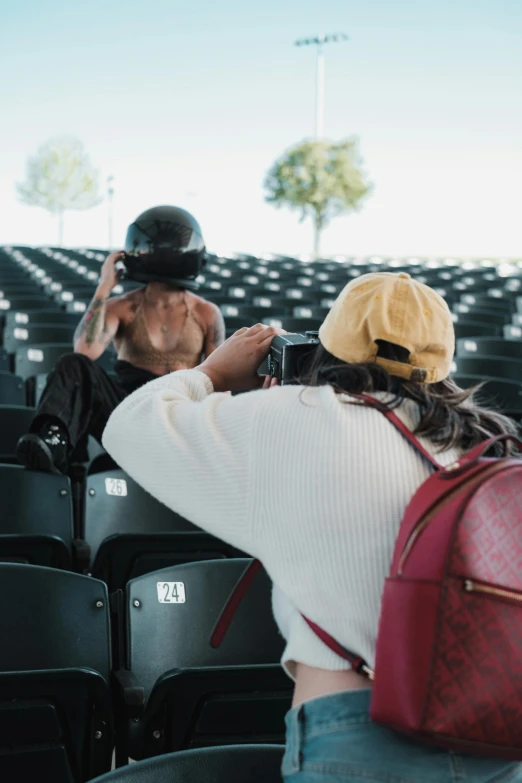 a woman taking a po in an empty stadium