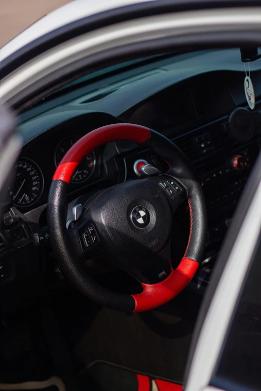 the inside of a modern car is red and black