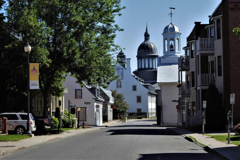 a street lined with small white buildings with domes on top of them