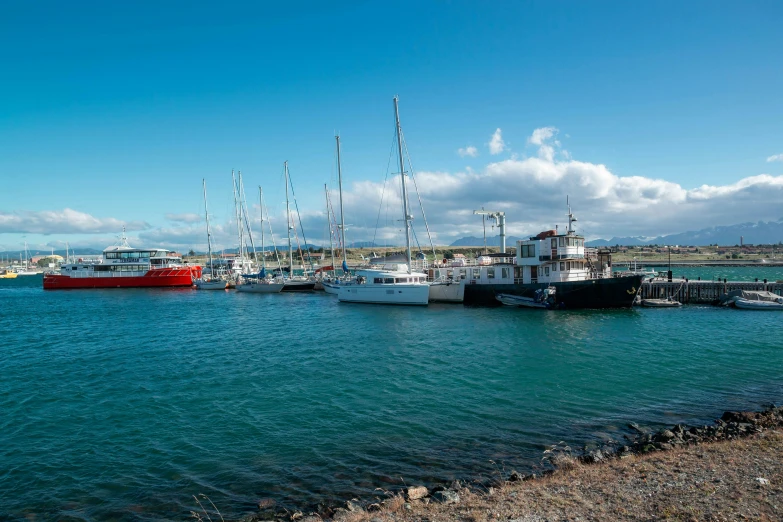 a harbor full of boats on water with blue sky