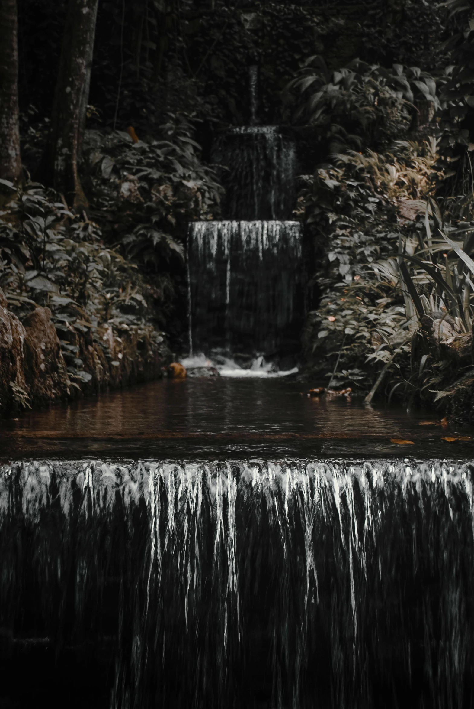 a beautiful waterfall in the middle of a forest