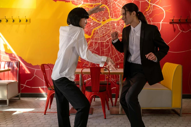 two men in business attire are dancing around a table