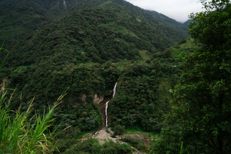 the stream runs into the valley below a waterfall