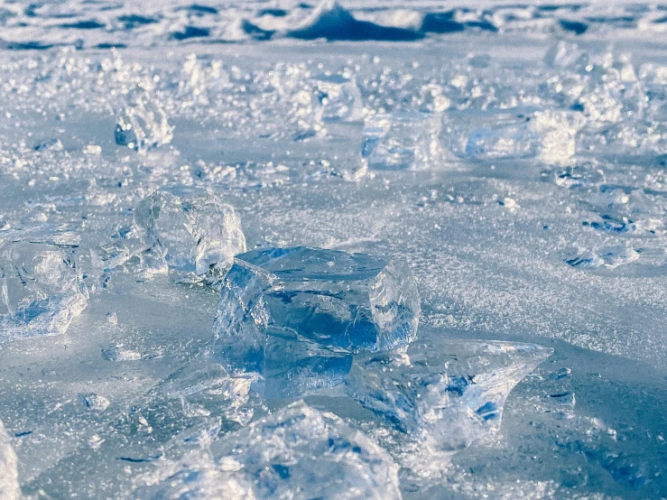 the ice on the surface is melting bright blue