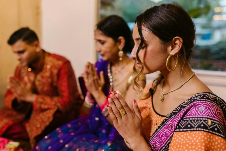 a beautiful woman with her hands folded at her knees