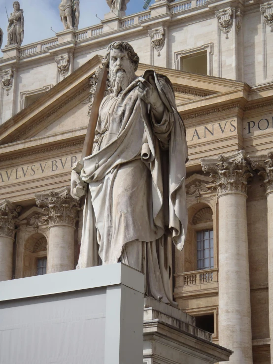 the statue of god in front of an ornate building