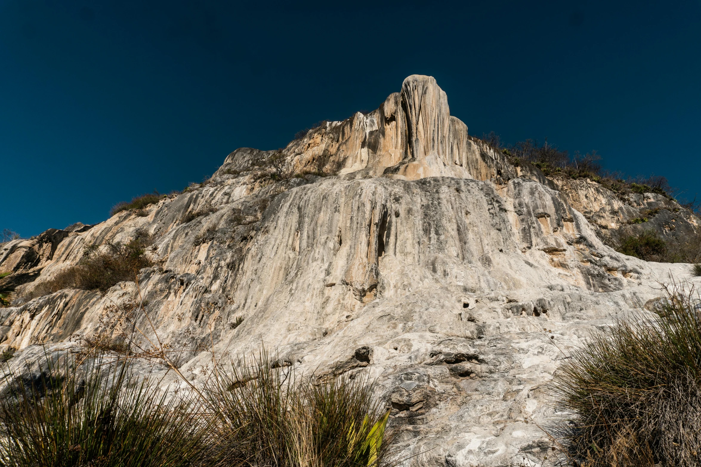 a tall hill with some vegetation on it