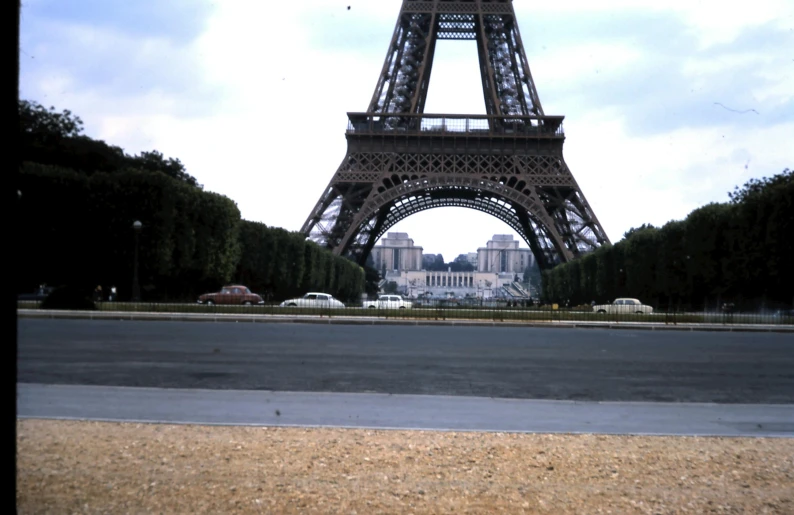 the eiffel tower towering over paris from across the street