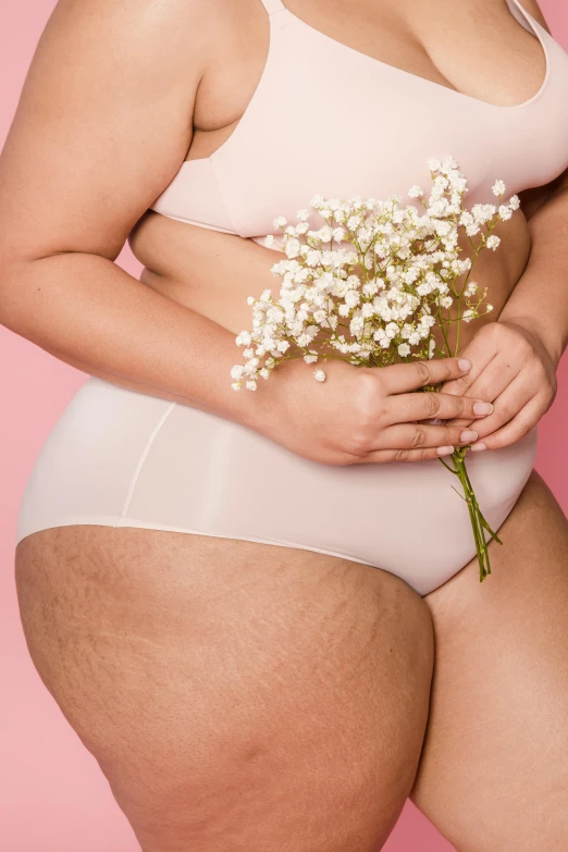 a large woman wearing a brief panties with flowers on her 