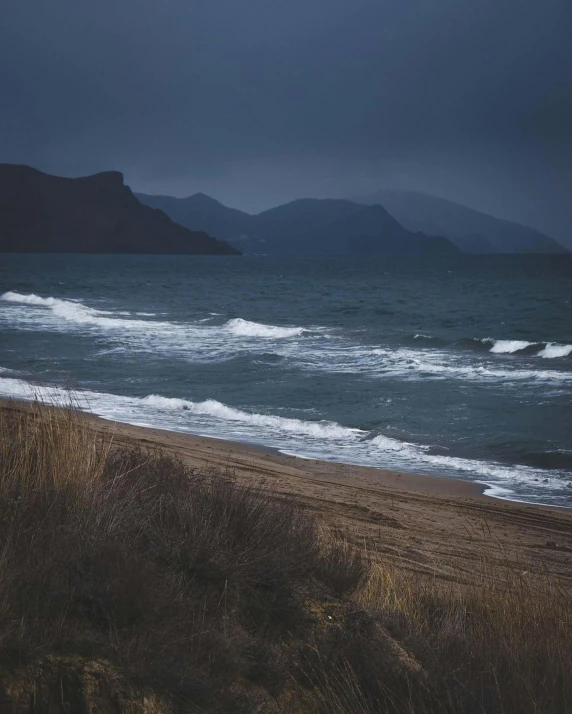 an image of some very pretty water by some hills