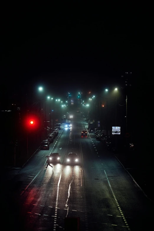 cars driving on a city street at night