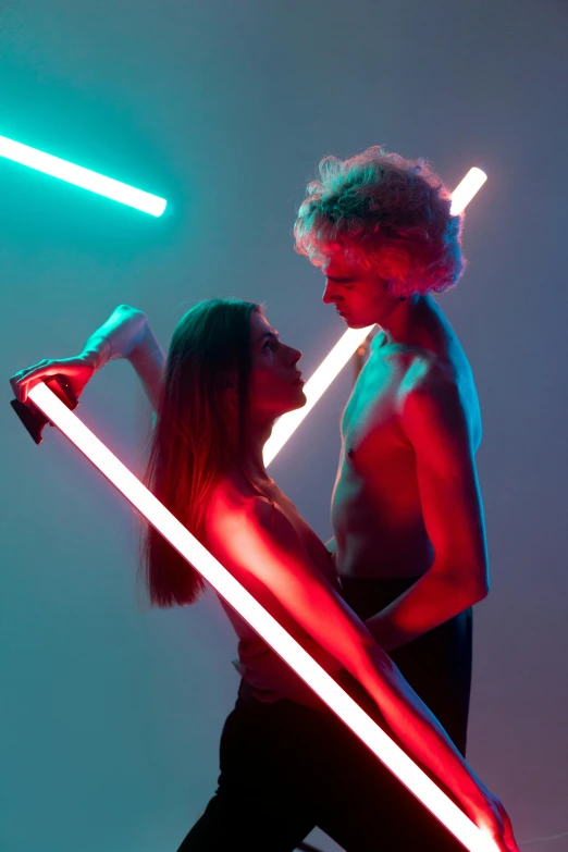 two people standing together and posing with one person holding the back light