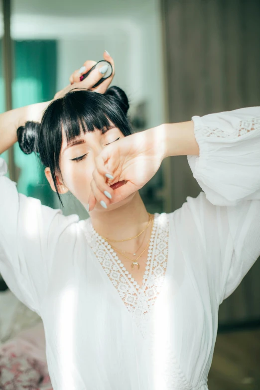 a girl putting on some pretty hair in the sun