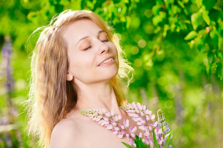 a woman holding her eyes closed and standing in the woods