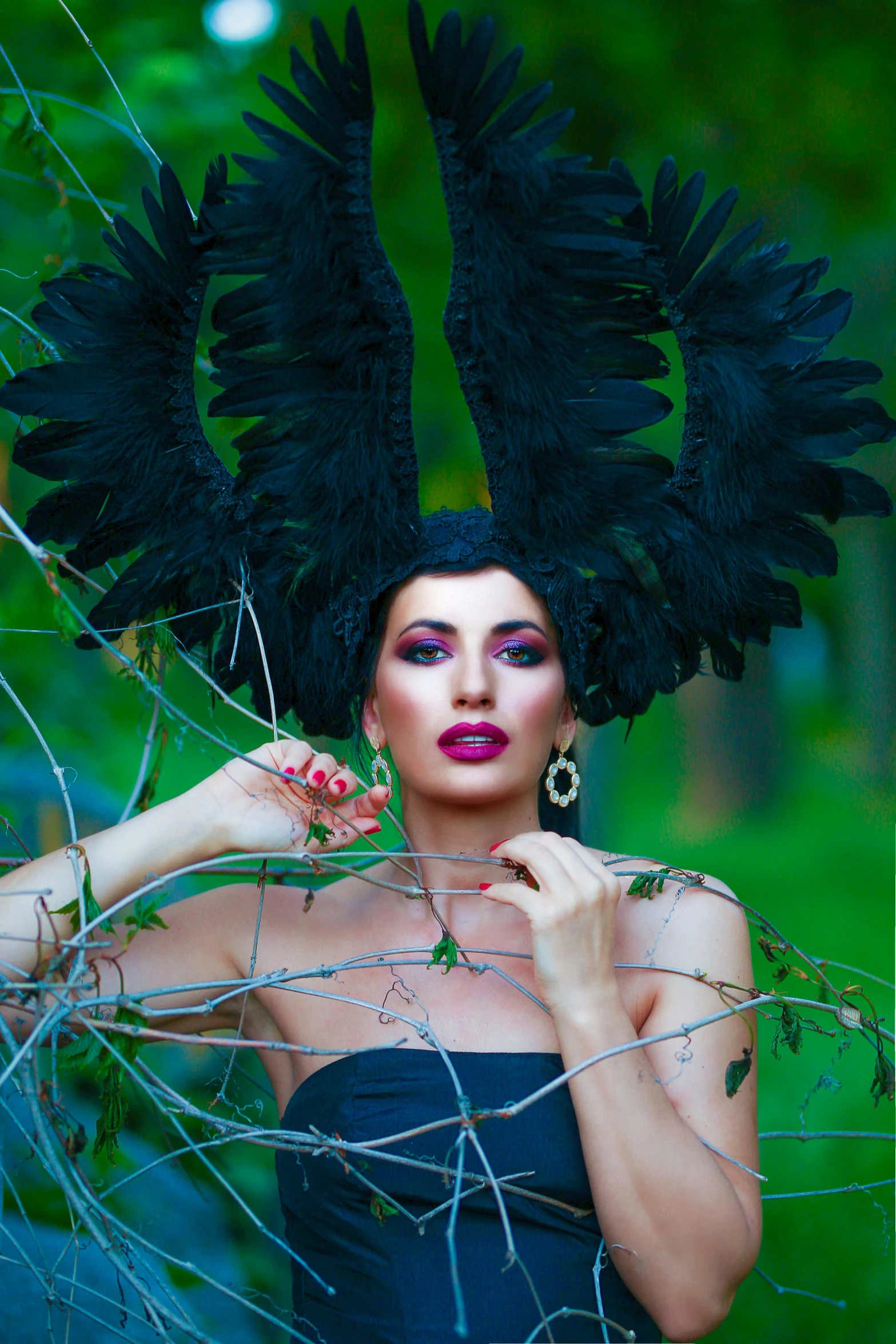 a woman with big wings posing in the woods