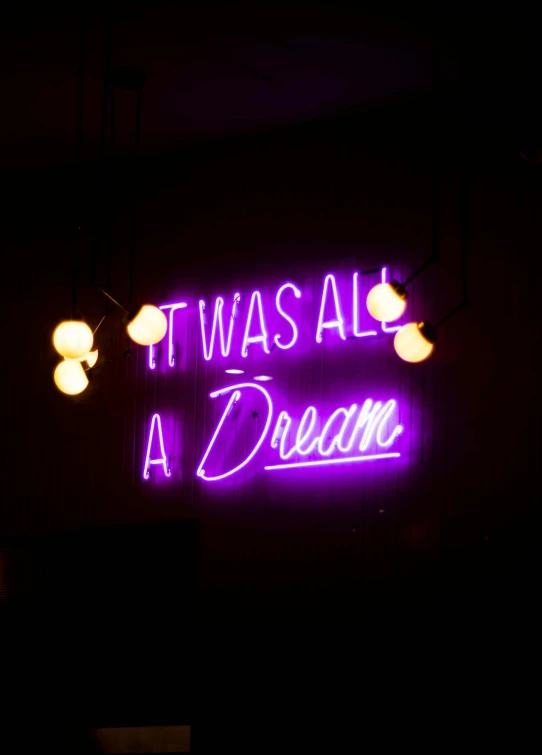 a neon sign on the wall says it was all a dream