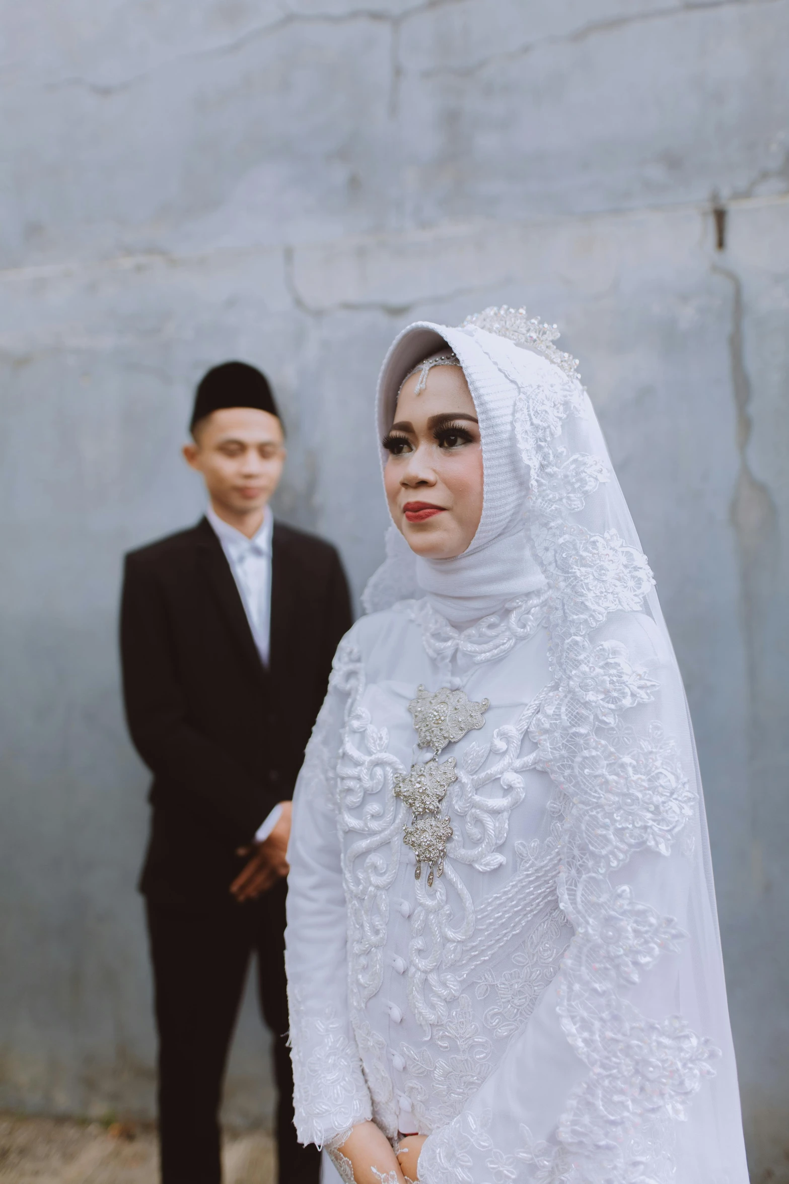 the man is standing next to his bride in a dress