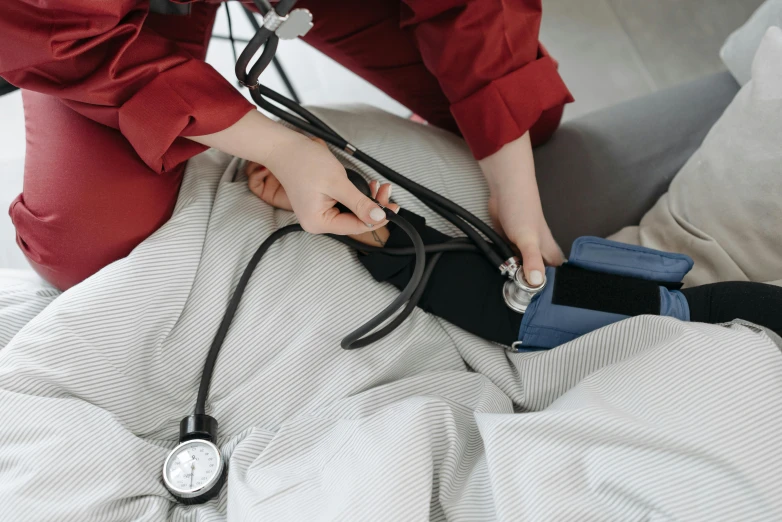 a woman is holding a stethoscope up to the patient