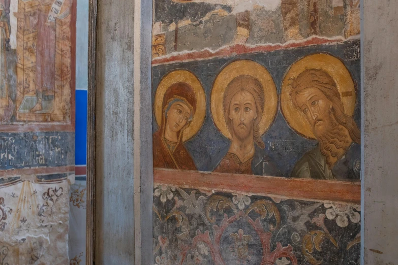 mosaics of the three faces of jesus and mary on a wall