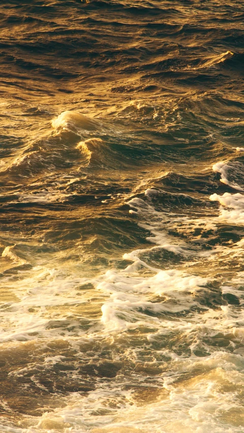 an ocean wave on the water with a surfer