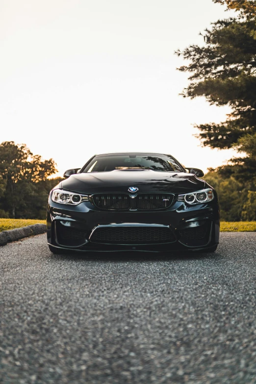 a black car is parked on the side of a road