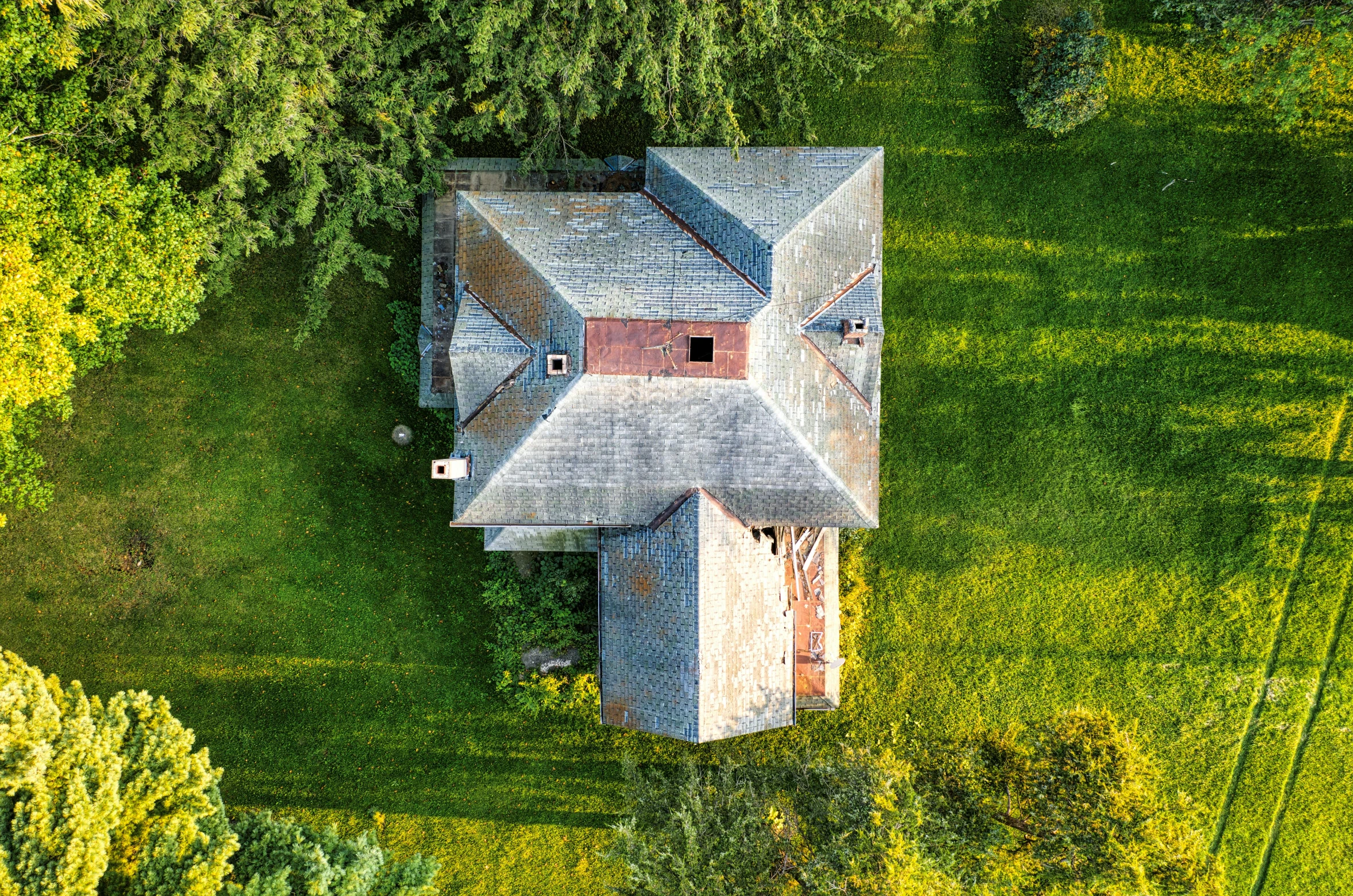 an aerial view of the house with all its windows boarded up