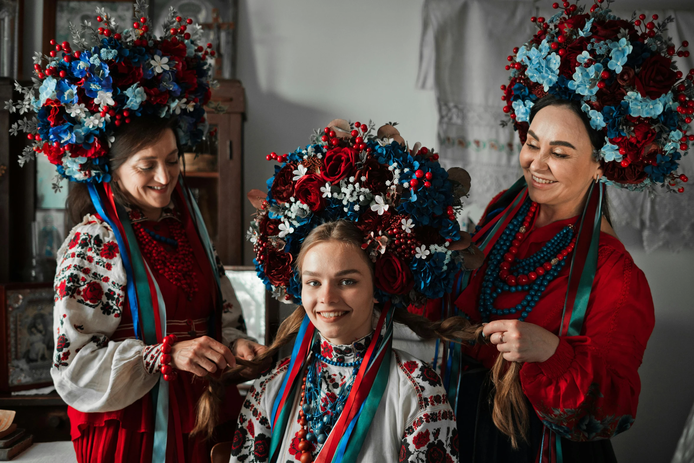 three women with wreaths of flowers at their hair