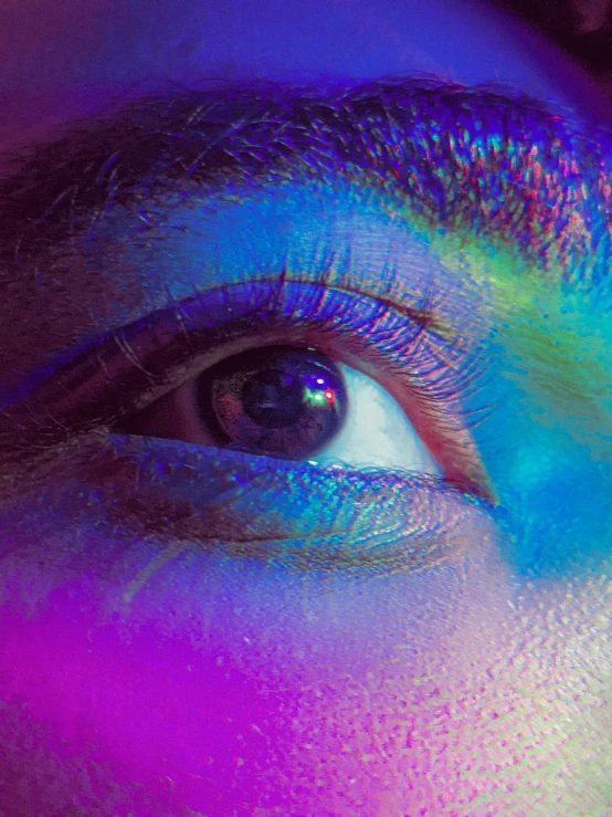 an eye with colored lights around it