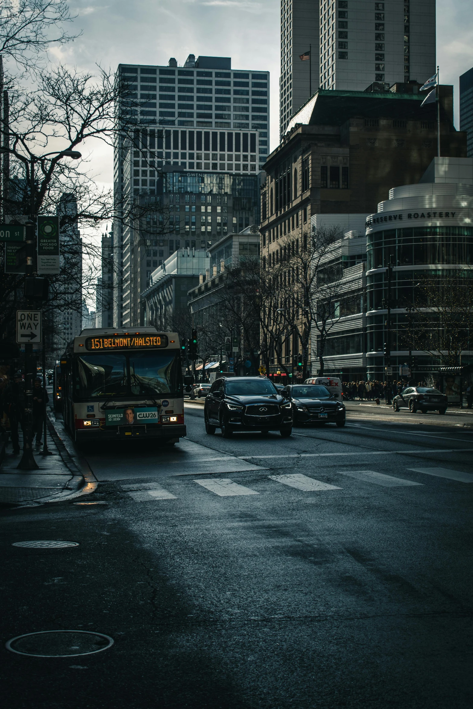 an empty street with cars and busses in a city