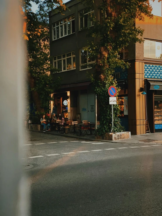 a city street with cars and bicycles parked on the curb