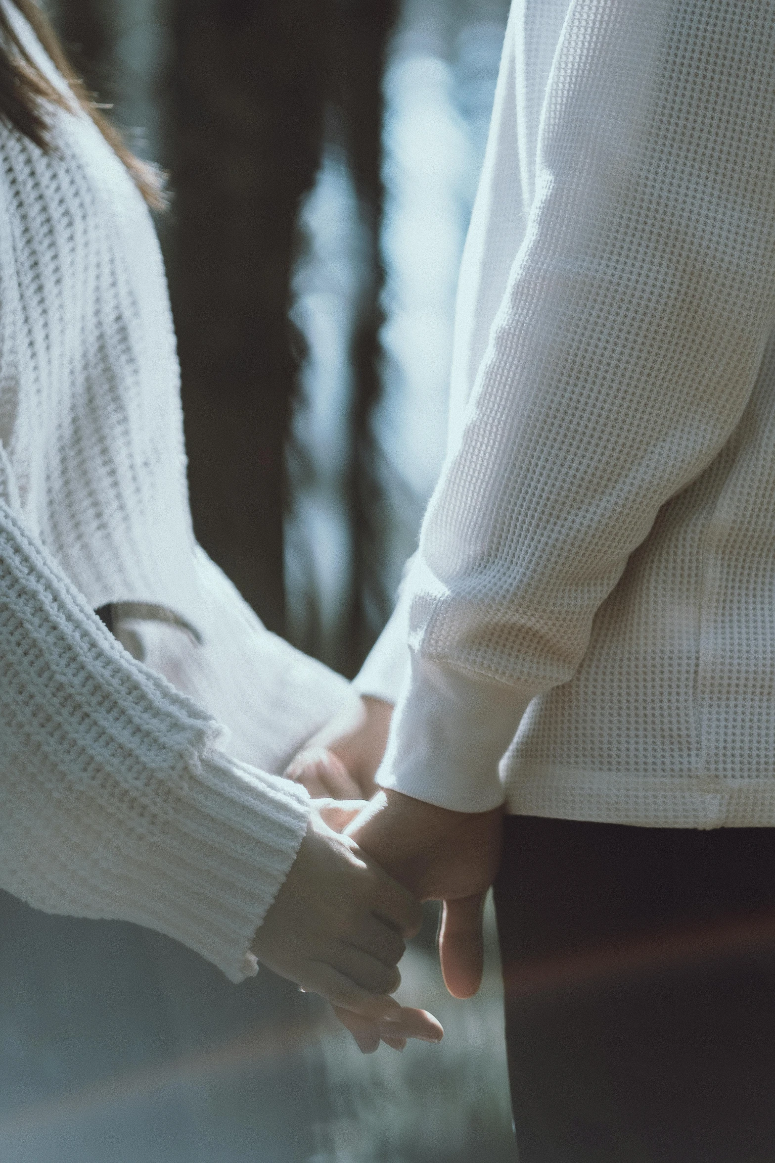 two people shaking hands next to each other