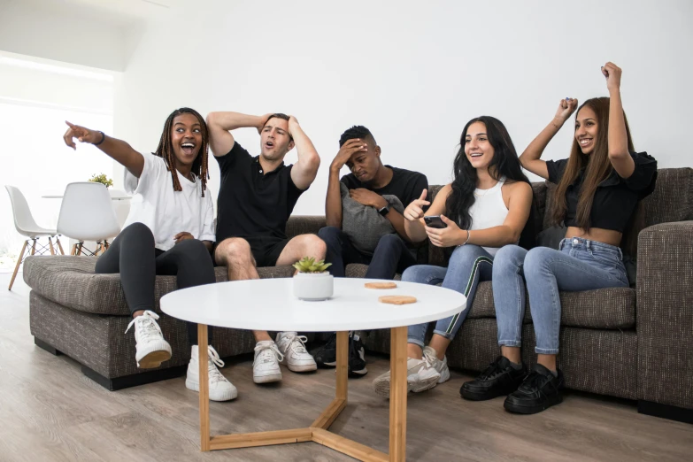 a group of young people sitting on top of a couch