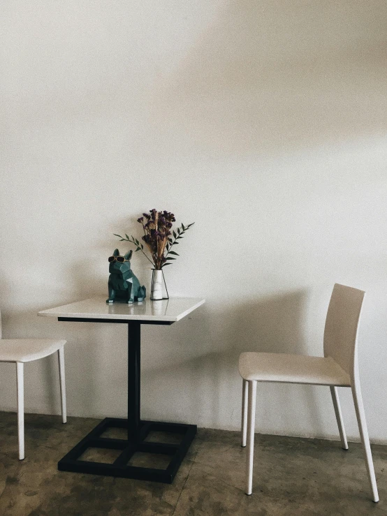 two chairs sitting at a table in a small room